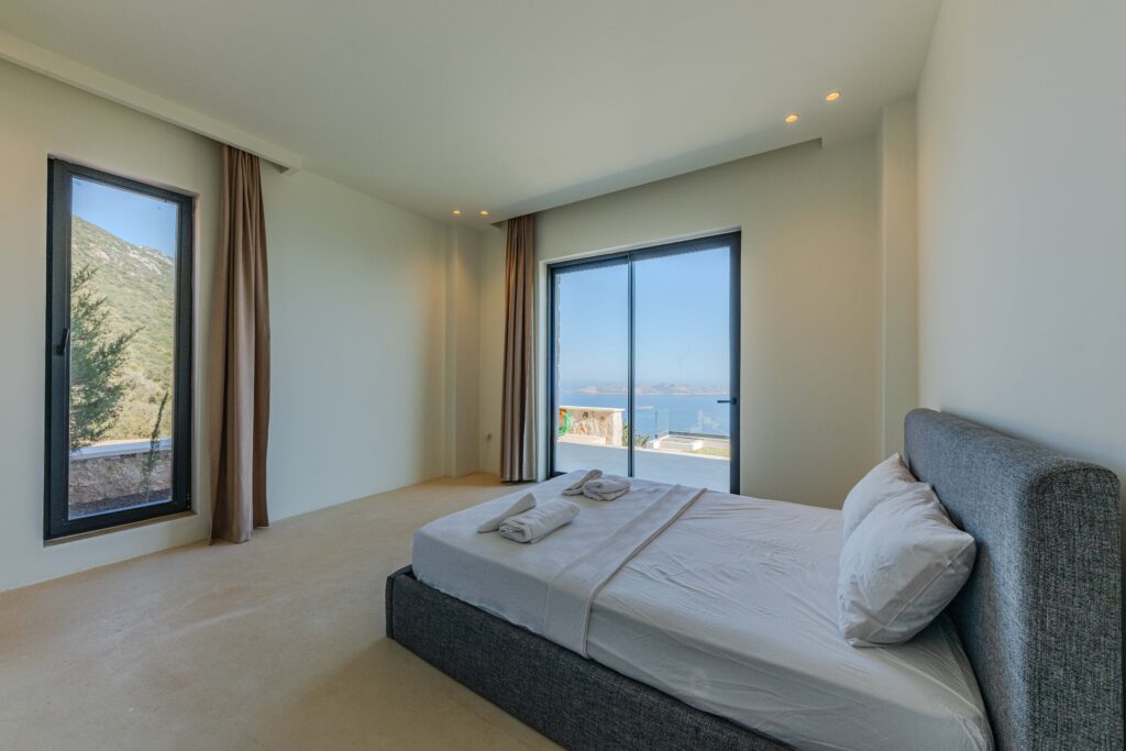 Spacious bedroom featuring minimalist design and stunning ocean views.